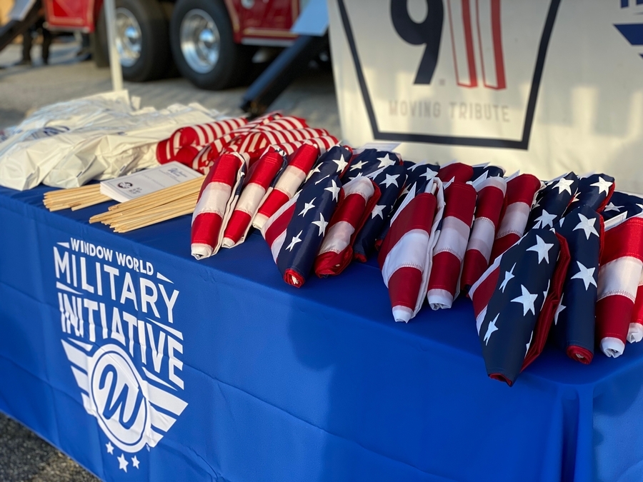 Table of folded American flags at a Window World Military Initiative event.