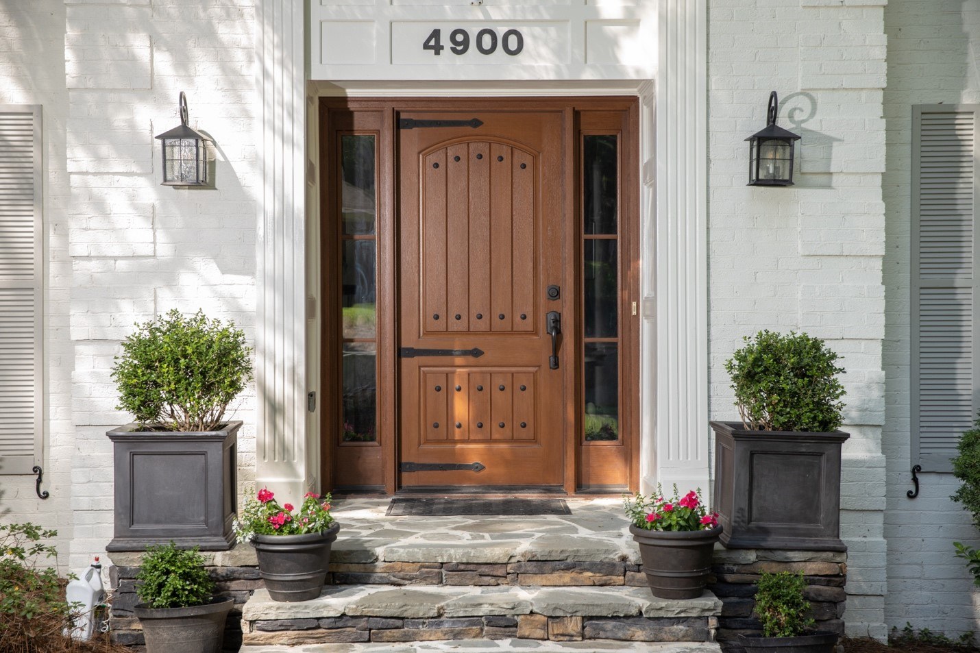 A large woodgrain energy-efficient entry door with contrasting hardware
