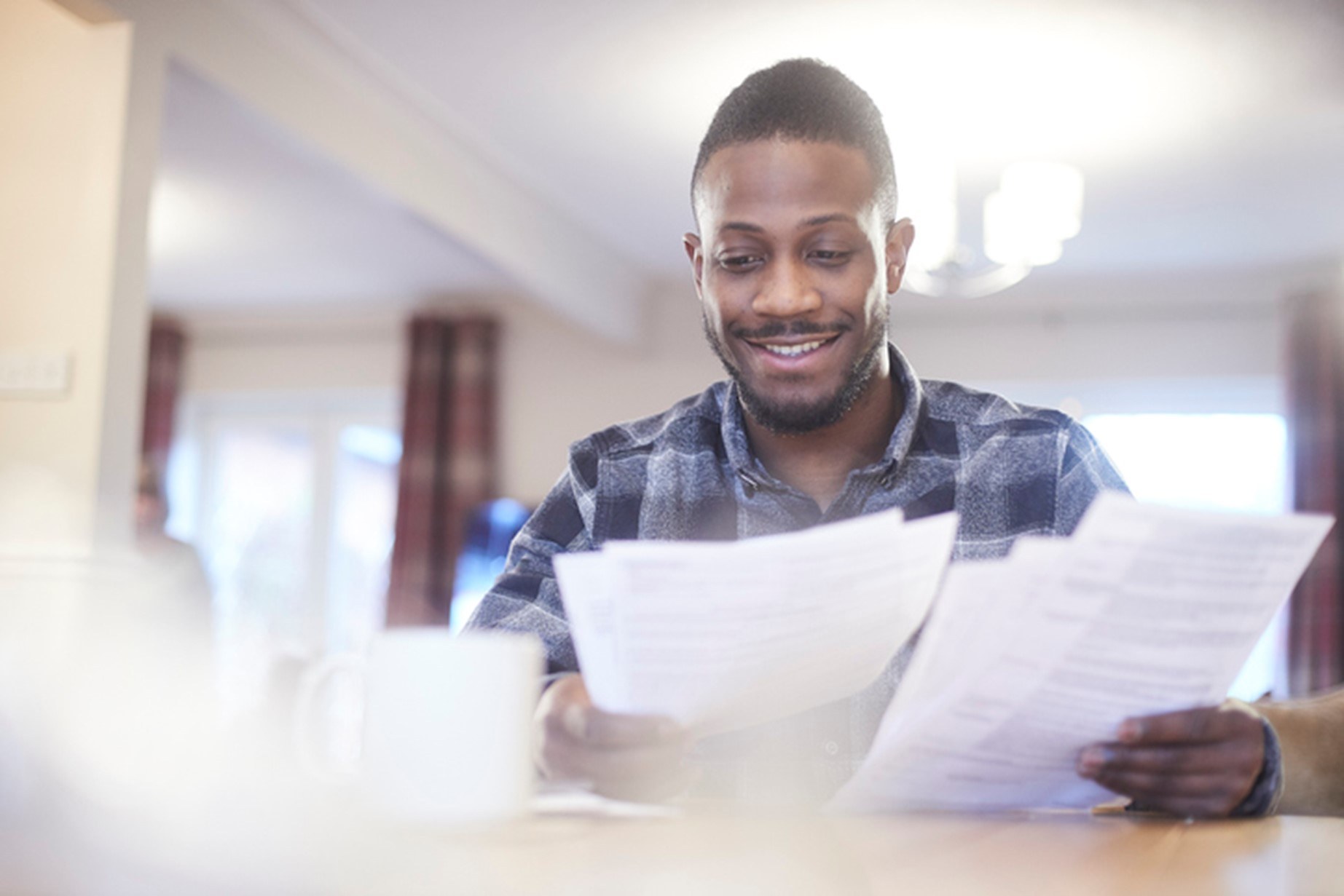 A person reading through a stack of papers