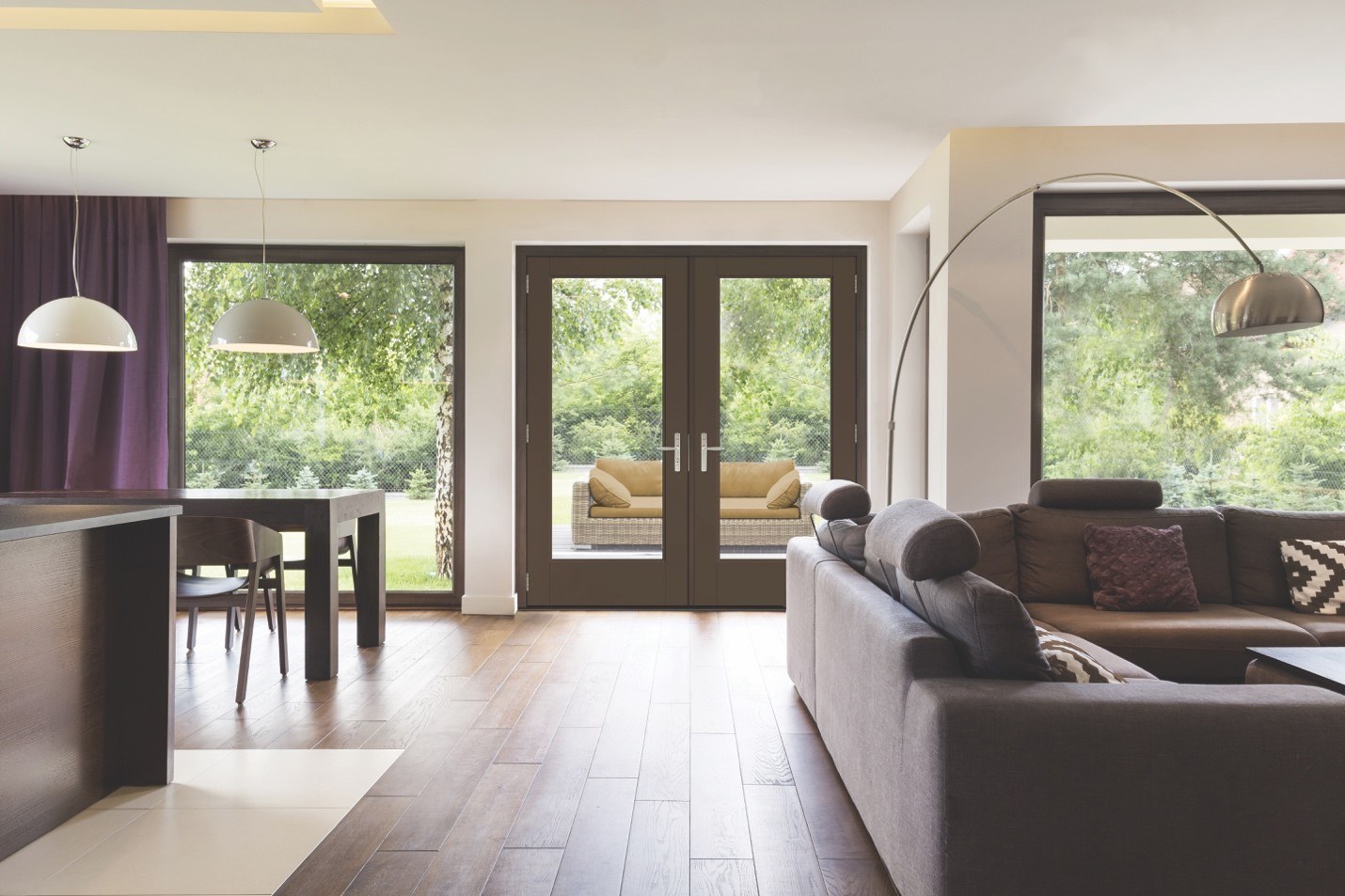 An open floorplan living space enhanced by large picture windows and energy-efficient patio doors with large glass panes 