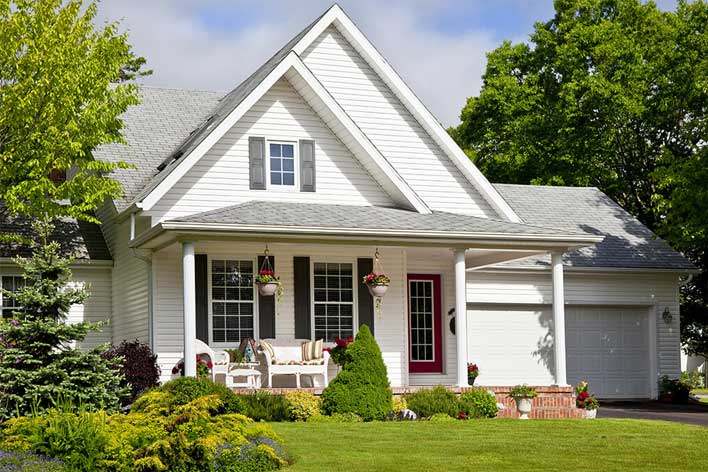 Front view of a white farmhouse-style home