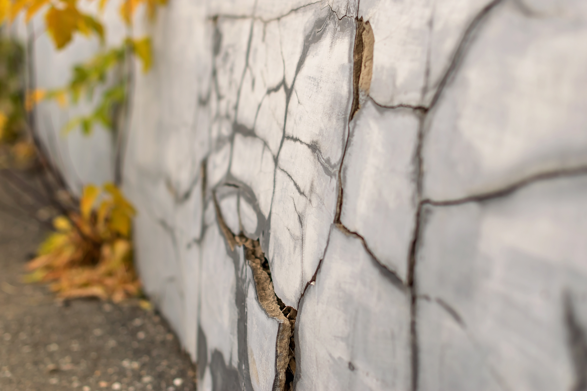 Close-up image of the cracked foundation of a home