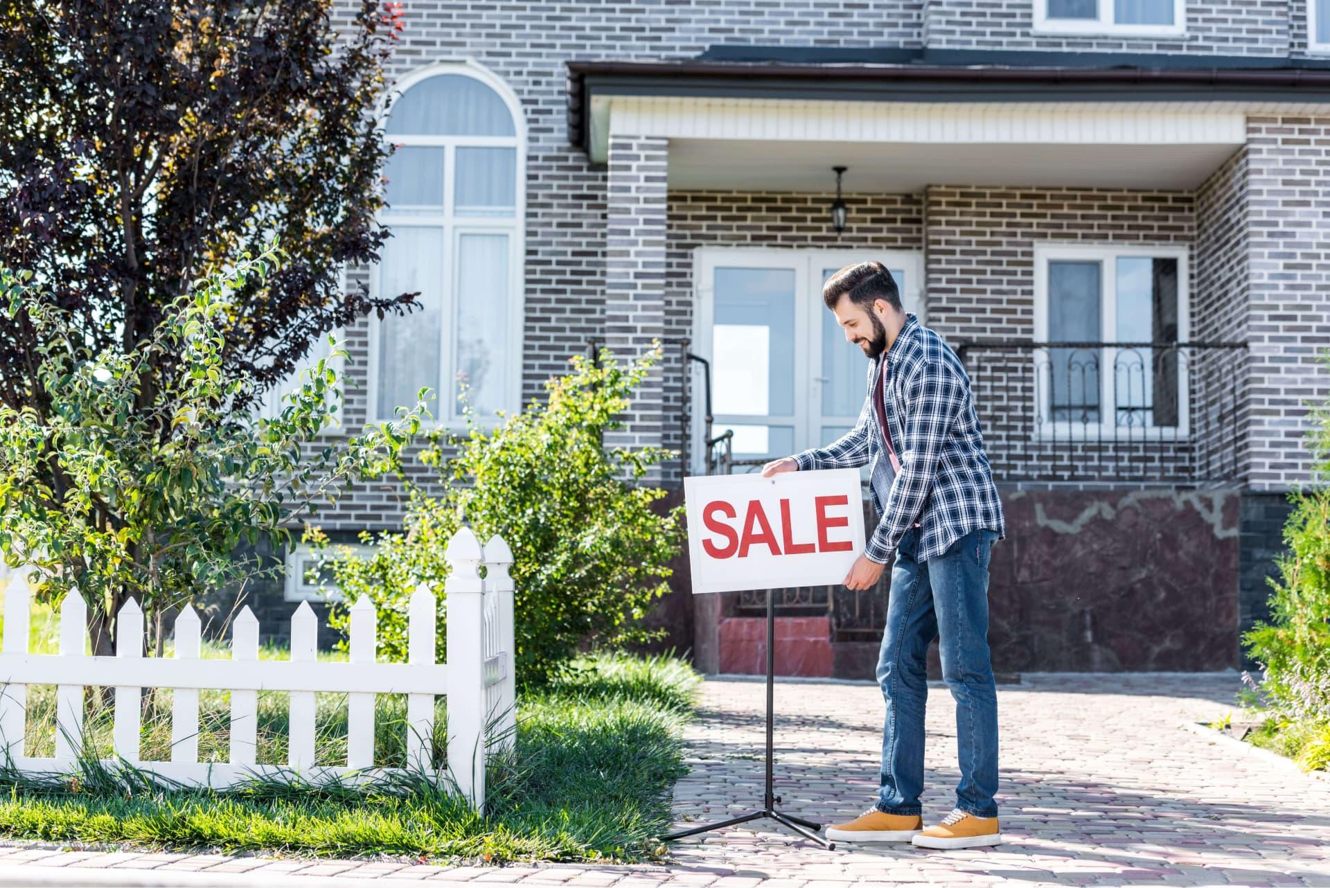 Home Owner Putting Down For Sale Sign Window World Hero 960