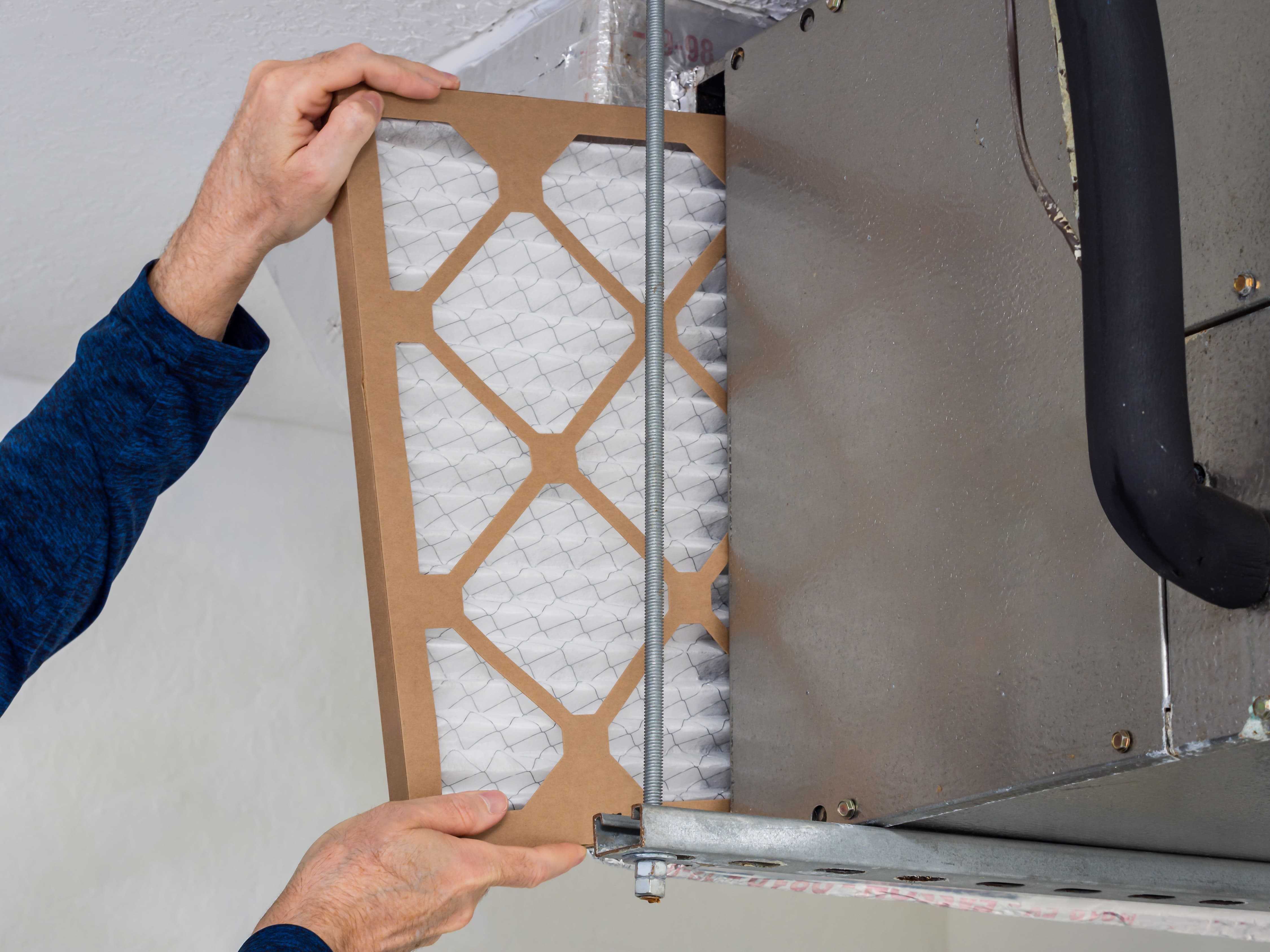 A new homeowner replacing the air filter in their first home.