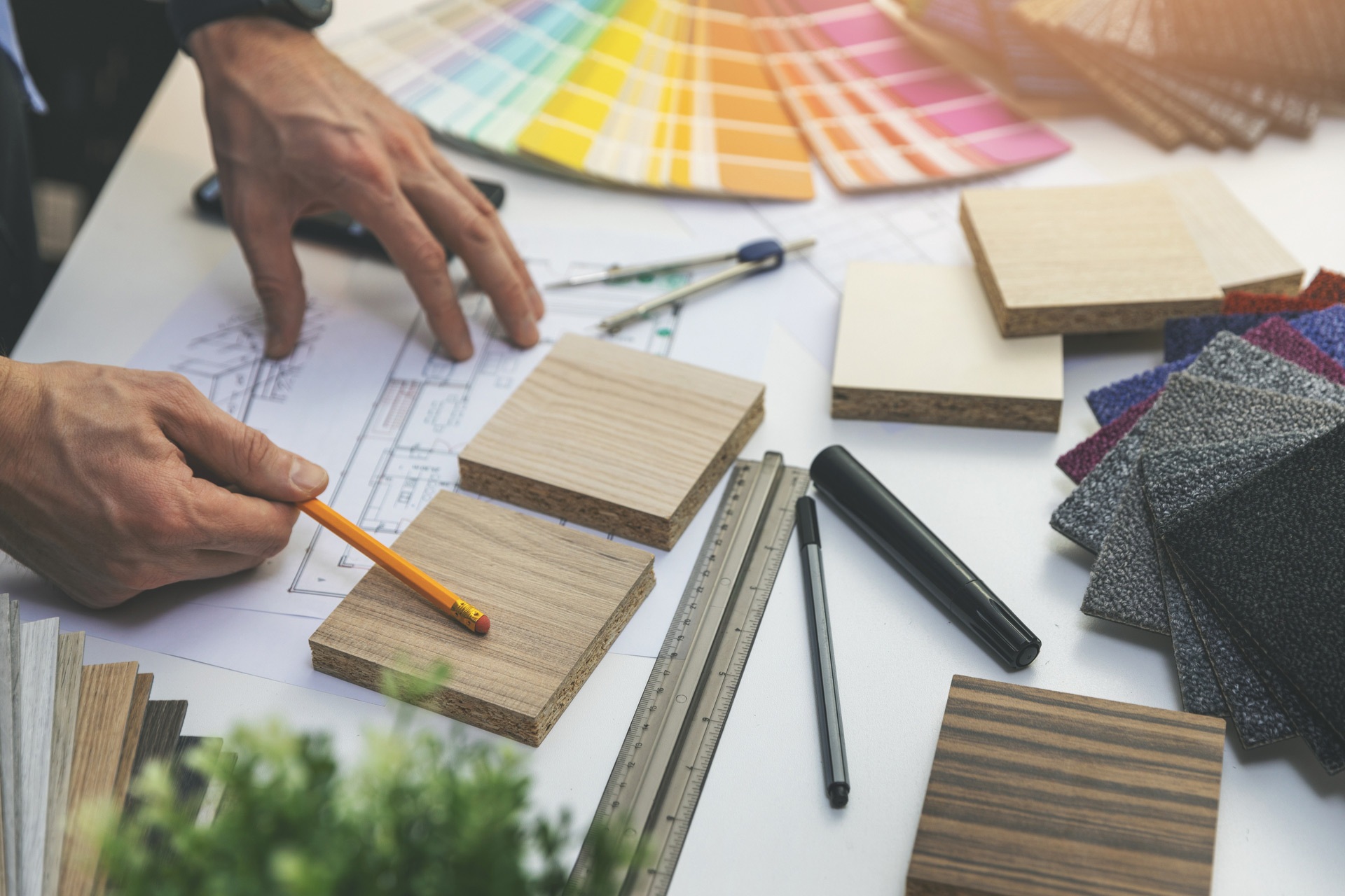 A person choosing color swatches and materials at the beginning of a home remodeling project