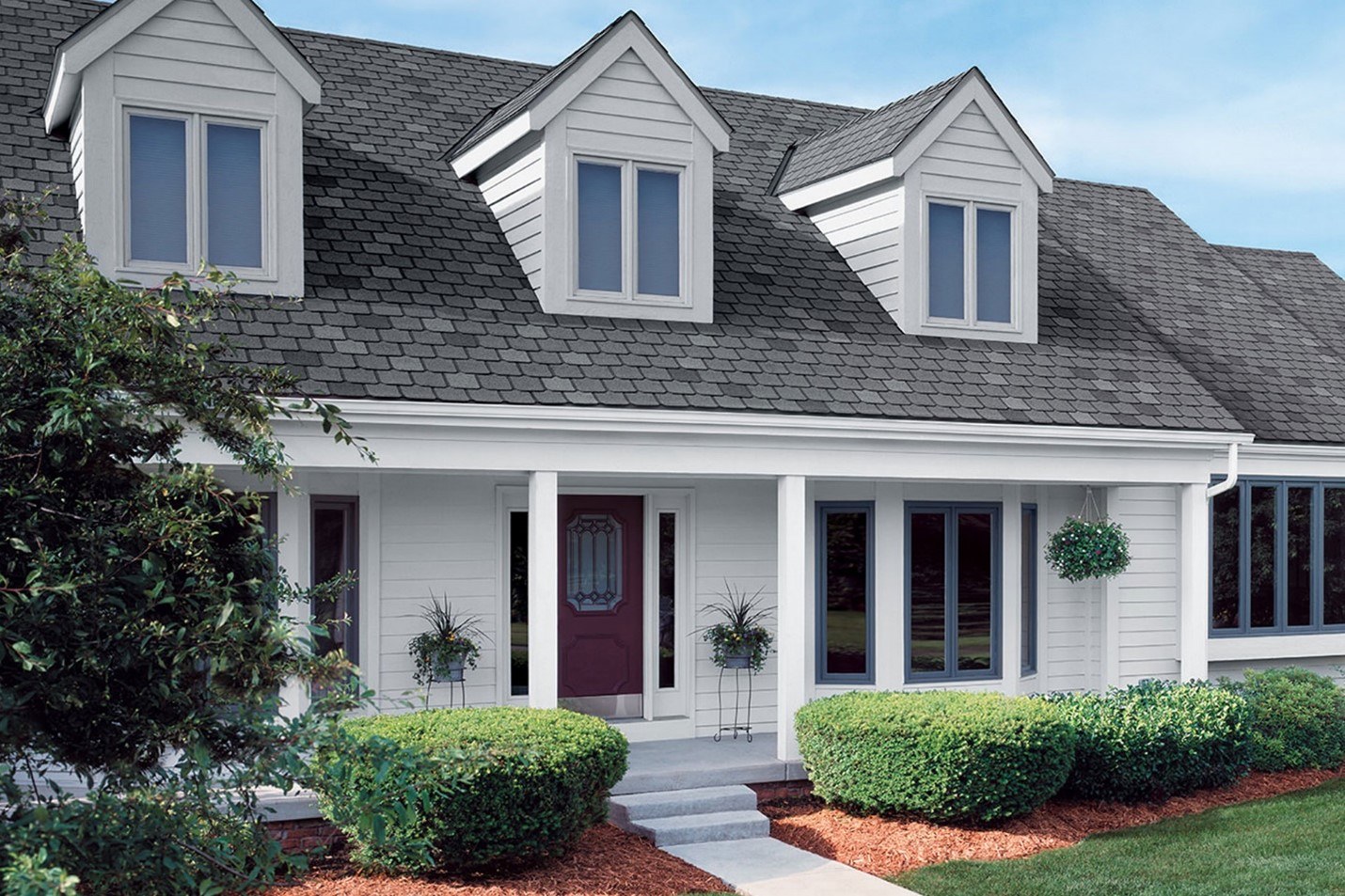 White farmhouse-style home with large front porch