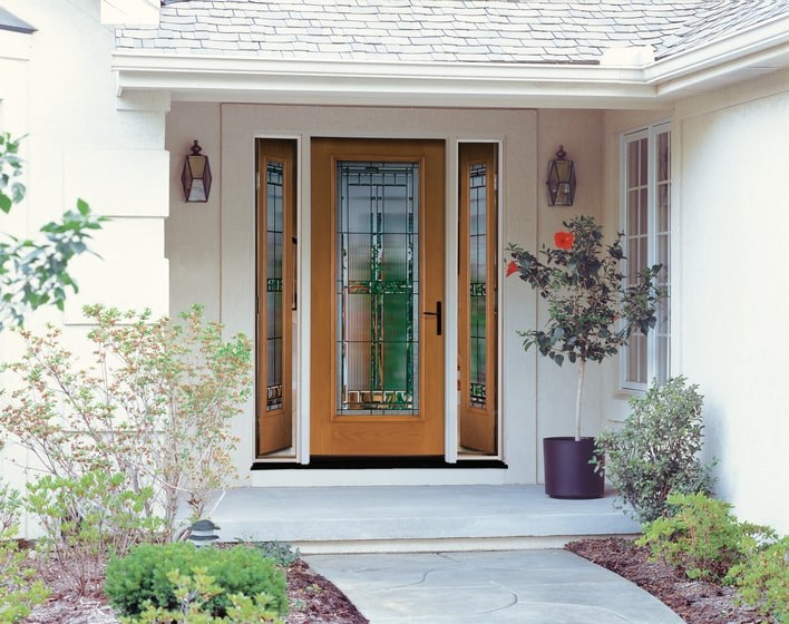 A front door flanked by sidelights, all of which feature decorative glass and woodgrain texture.