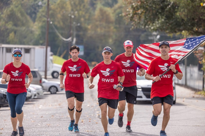 Team RWB carry the American flag to Window World's corporate office Team RWB carry the American flag to Window World's corporate office