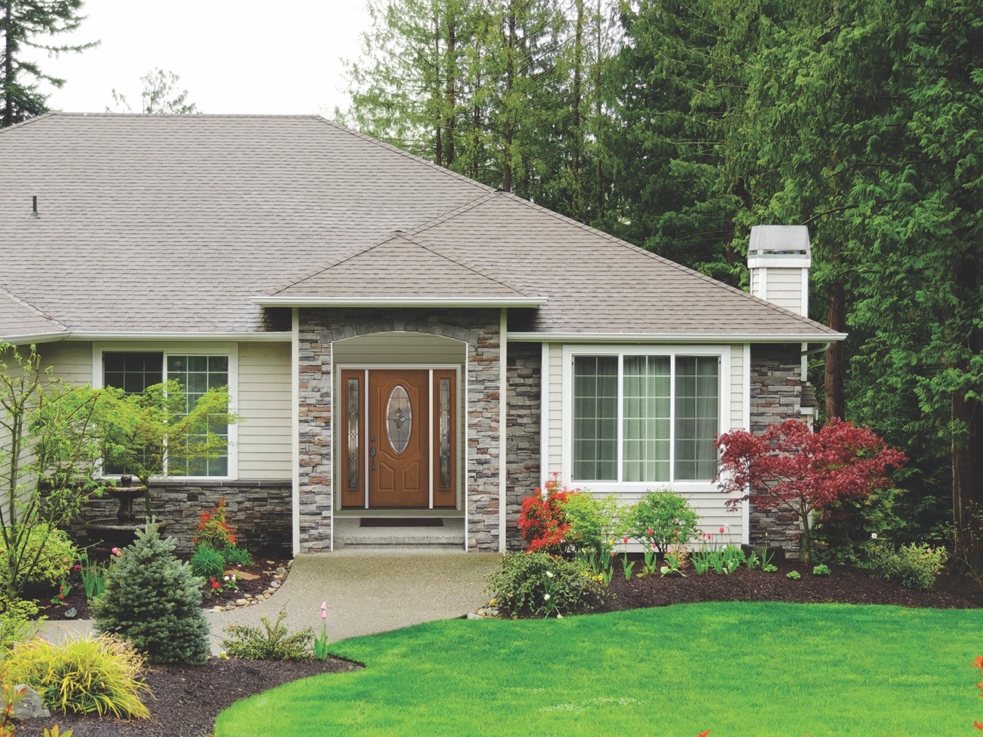 The front view of a well-maintained home, including its energy-efficient front door