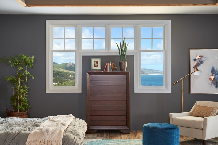 Double-hung white sash window contrasting against a gray wall