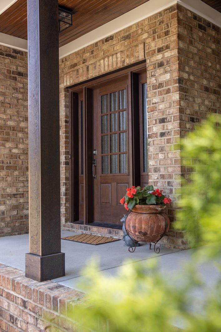 A brick house with a planter by the front door