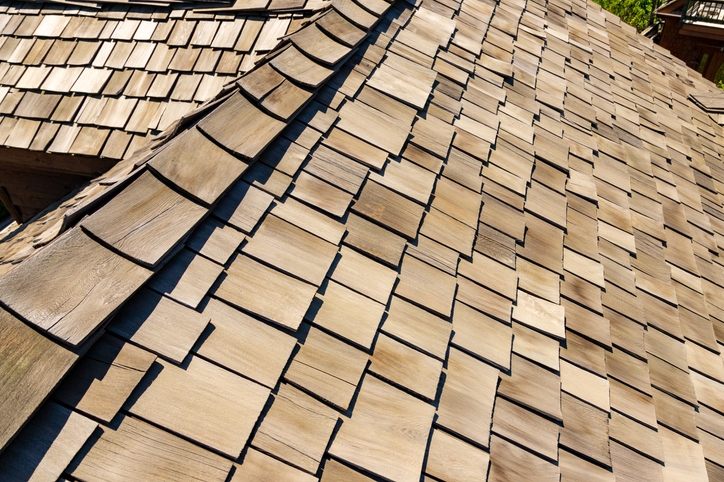 An expanse of roof with authentic cedar shake shingles made from natural cedar materials.