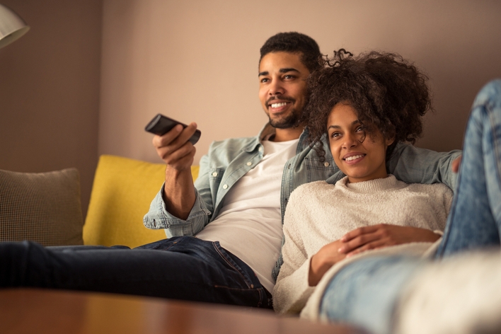 Couple watching TV together Couple watching TV together