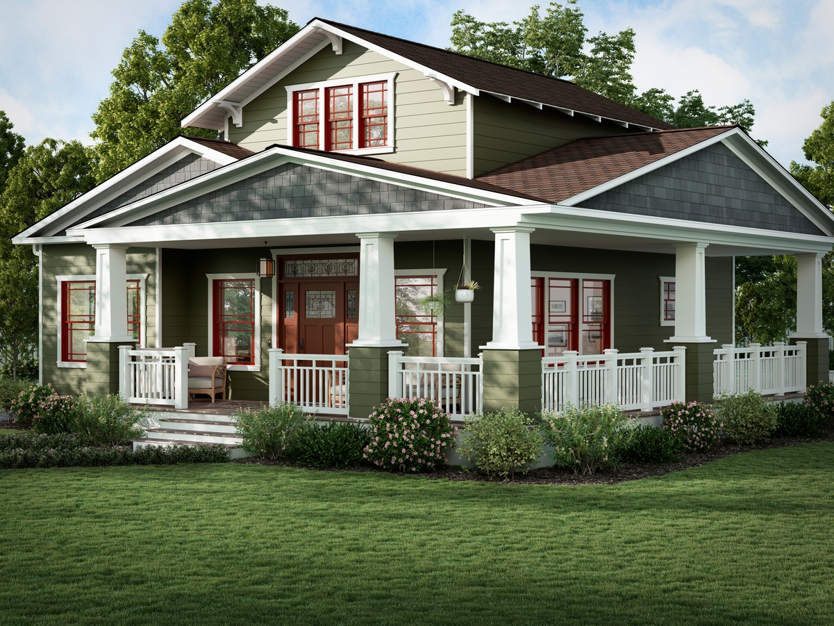 A craftsman style house with green siding and red windows