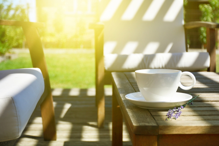 Coffee cup sitting on a porch table