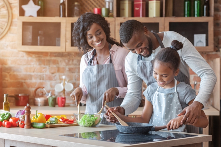 Family cooking together in kitchen