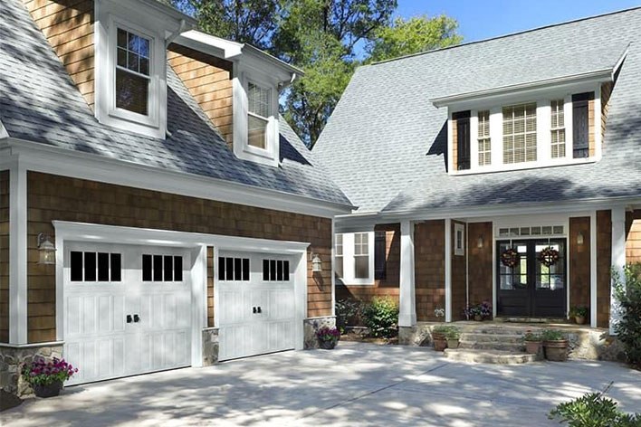 White garage doors on a tan home