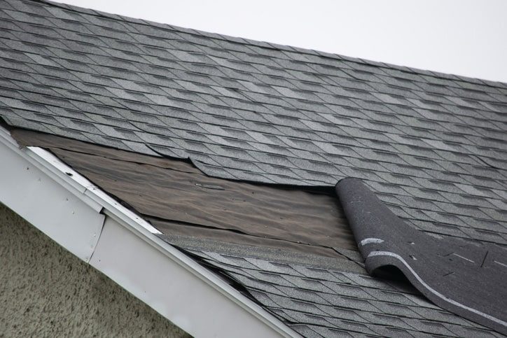 A closeup of roof damage from a storm