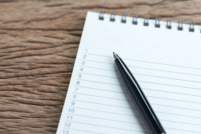A notepad list and pen A notepad list and pen