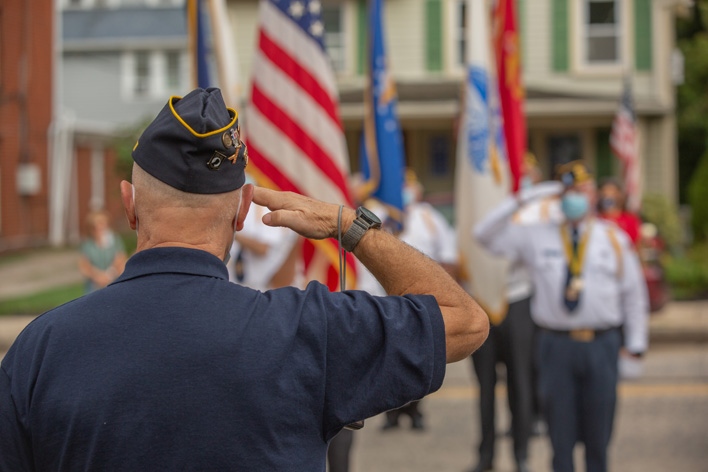 A veteran salutes the American flag