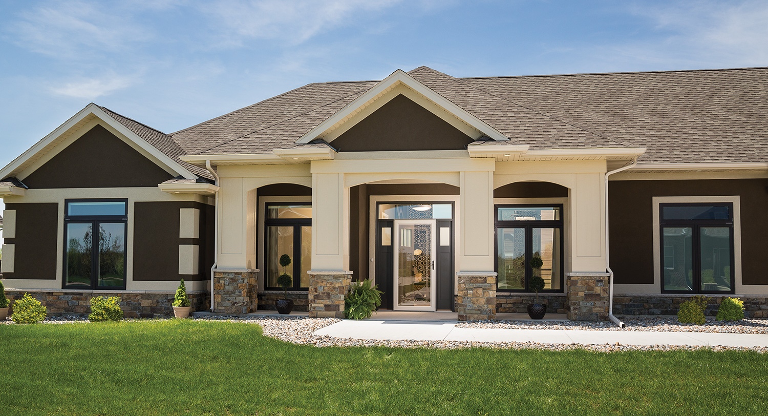 glass security storm door on a brown and tan house