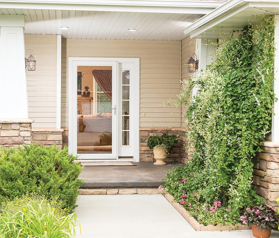 sidewalk to front porch of a house with a full view storm door