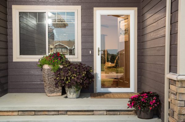 full view storm door on a house with brown vinyl siding