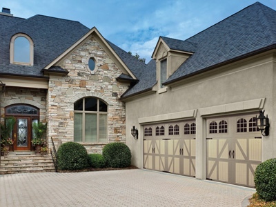 A tan-colored home with an Amarr Classica-style garage door.