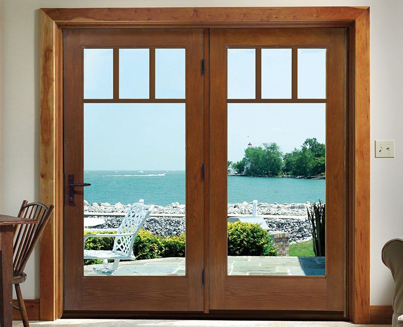 Wooden hinged patio door with a lakeside view.