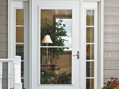 A white retractable storm door on a light gray home.